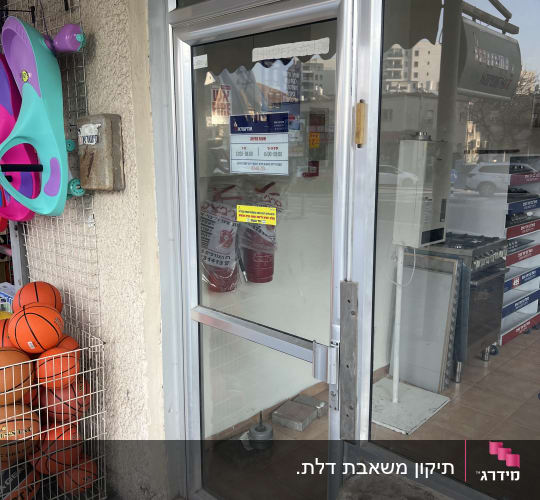 דלת אלומיניום עם ידית מתכת בחנות